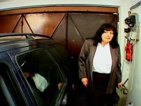 Fat mature with big tits sucking cock in garage